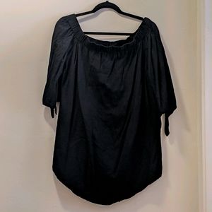 Black off the shoulder dress.